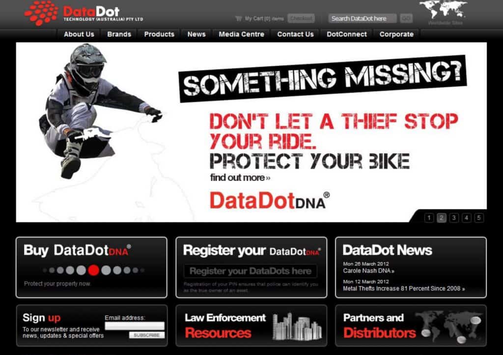 Motorcycle rider with DataDot DNA security sticker on bike.